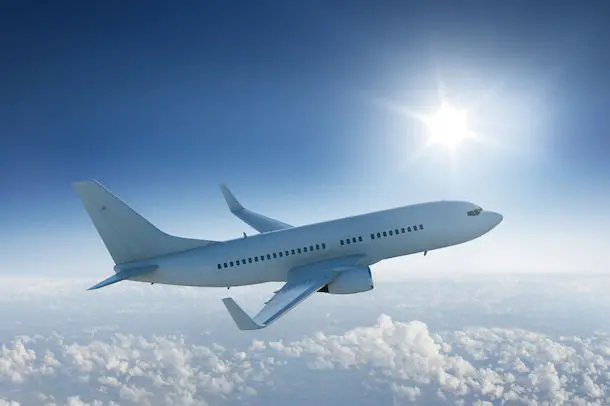 <p>Airliner flying past the sun - in blue sky</p>\\n