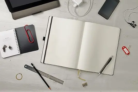 Workplace. Empty notepad, tablet pc and smart phone on white wooden table 