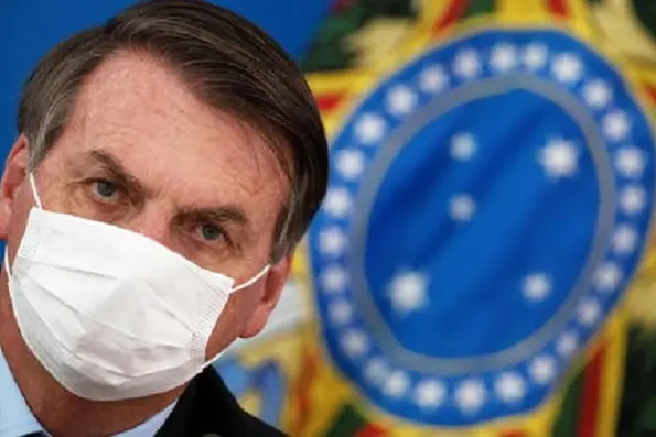 epa08532724 (FILE) - President of Brazil Jair Bolsonaro attends a press conference on the measures taken by the government against the spread of the coronavirus, in Brasilia, Brazil, 18 March 2020 (reissued 07 July 2020). Bolsonaro, 65, reported on 07 July 2020 that he has tested positive for COVID-19 and has begun to be treated with chloroquine.  EPA/Joedson Alves *** Local Caption *** 56138668