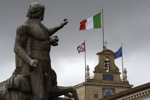 The Italian flag floats over the Quirinale presidential palace on April 2, 2013 in Rome. The two working groups named by the Italian President Giorgio Napolitano started their meetings the same day to come up with a programme of reforms for any future government amid a deadlock between the main parties.  AFP PHOTO / ANDREAS SOLARO        (Photo credit should read ANDREAS SOLARO/AFP/Getty Images)