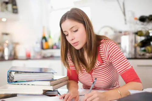 Woman studying in kitchen