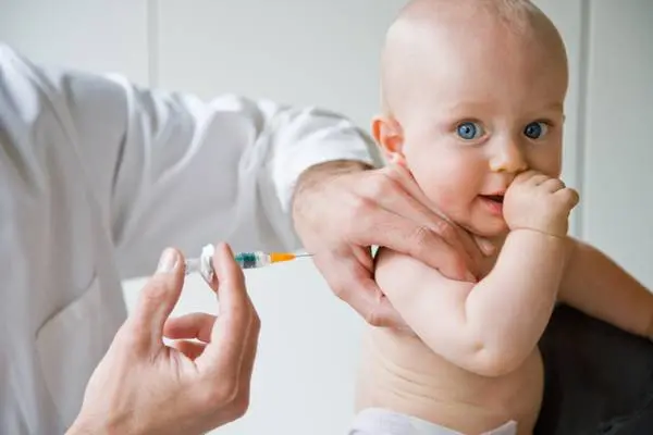 9 months old baby receiving vaccination.  