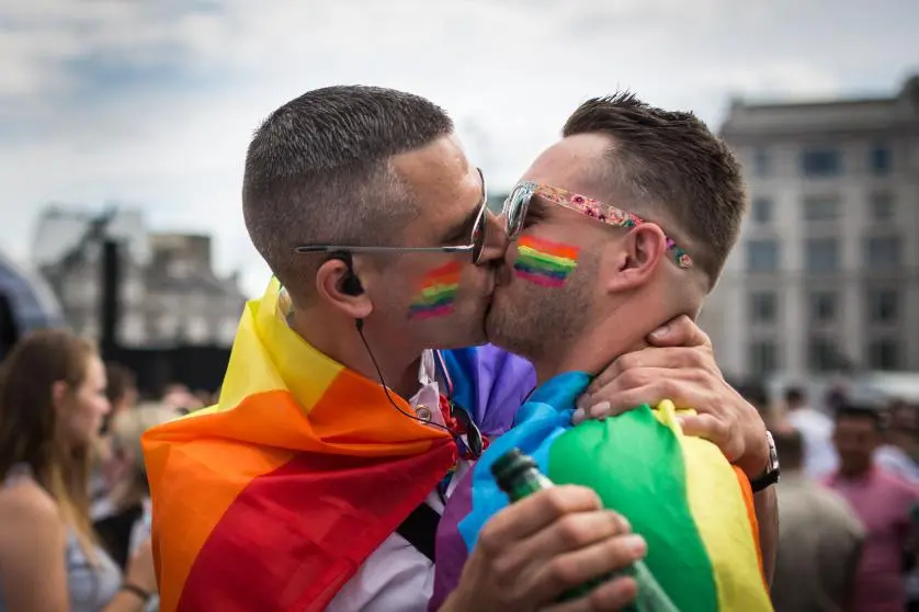 LONDON, ENGLAND - JUNE 27:  A couple kiss in Trafalgar Square after the annual Pride in London Parade on June 27, 2015 in London, England.  Pride in London is one of the world\\'s biggest LGBT+ celebrations as thousands of people take part in a parade and attend performances at various locations across the city. (Photo by Rob Stothard/Getty Images)