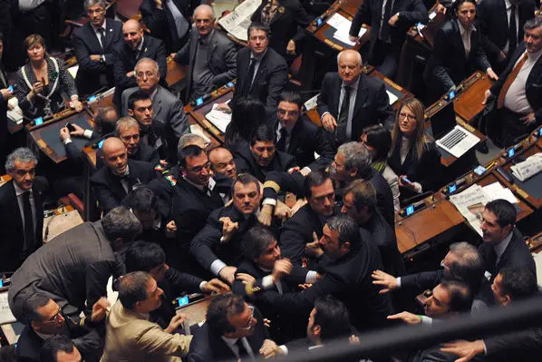 Members of the Northern League and Futura e Liberta (FLI) groups at the parliament argue during a confidence vote at the Chamber of Deputies, the Italian lower house, on December 14, 2010 in Rome. Italy held its breath as lawmakers staged a knife-edge confidence vote on Prime Minister Silvio Berlusconi\\'s government that could bring down the flamboyant Italian leader. AFP PHOTO / ANDREAS SOLARO (Photo credit should read ANDREAS SOLARO/AFP/Getty Images)