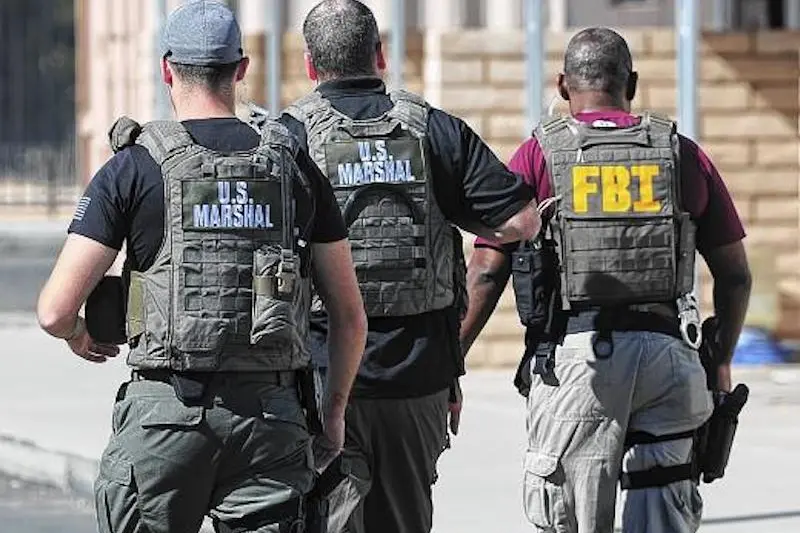 Buy this photo at Photos.YumaSun.com\\tPHOTO BY CRAIG FRY/YUMA SUN\\n\\nAgents with the U.S. Marshal Service and FBI walk towards the residence of a registered sex offender Monday afternoon to conduct a compliance check.  The subject the agents were looking to speak with was not at the residence.\\n