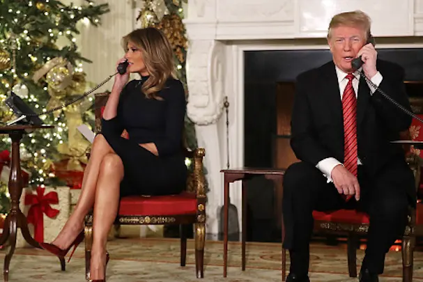WASHINGTON, DC - DECEMBER 24: U.S. President Donald Trump (R) and first lady Melania Trump take phone calls from children as they participates in tracking Santa Claus\\' movements with the North American Aerospace Defense Command (NORAD) Santa Tracker on Christmas Eve in the East Room of the White House December 24, 2018 in Washington, DC. This is the 63rd straight year that NORAD has publicly tracked Santa?s sleigh on its global rounds. (Photo by Chip Somodevilla/Getty Images)