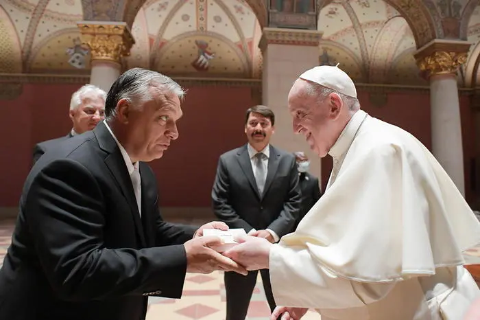 epa09463100 A handout picture provided by the Vatican Media shows Pope Francis (R) and Hungarian Prime Minister Viktor Orban (L) exchanging gifts as Hungarian President Janos Ader (C, back) looks on during their meeting in Budapest, Hungary, 12 September 2021. The pontiff is in Budapest for the first leg of his Apostolic visit to Hungary and Slovakia from 12 to 15 September 2021.  EPA/VATICAN MEDIA HANDOUT  HANDOUT EDITORIAL USE ONLY/NO SALES