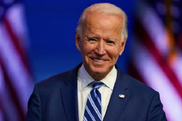 President-elect Joe Biden pauses to smile as listens to media questions at The Queen theater, Tuesday, Nov. 10, 2020, in Wilmington, Del. (AP Photo/Carolyn Kaster)