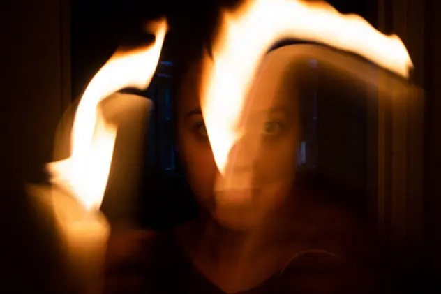 Woman in horror. Playing with fire.