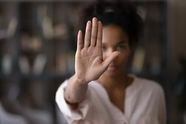 Close up focus on female mixed race palm hand showing stop sign, serious african american woman protesting against bullying in society, sexual or racial discrimination, denying family abuse indoors.