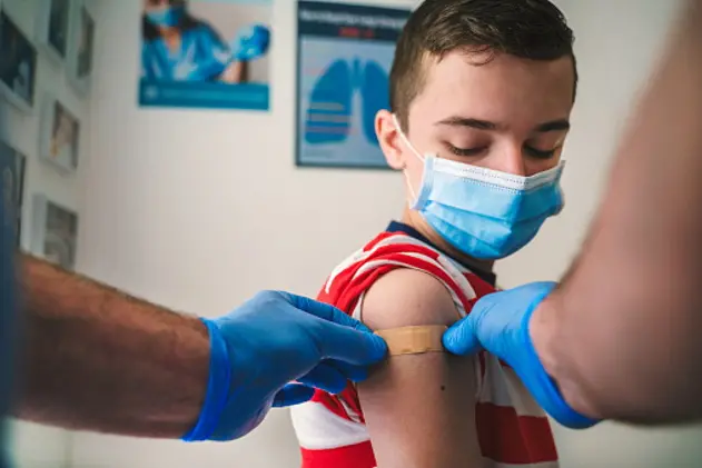 Patient Getting Vaccinated against COVID-19. Child, teenage boy vaccination. Coronavirus epidemic. Copy space.