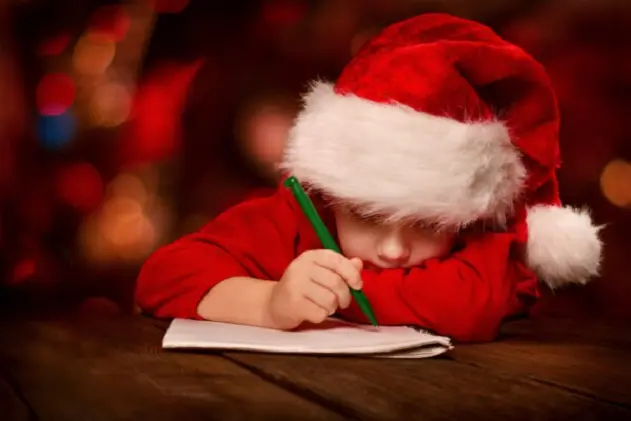 Christmas child writing letter to Santa letter over abstract background\\r