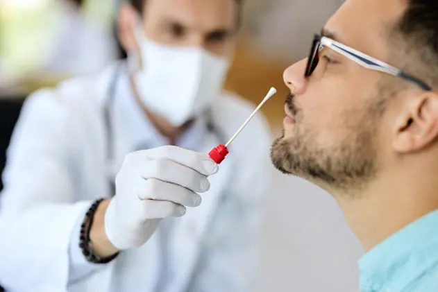 Close-up of young man getting PCR test at doctor\\'s office during coronavirus epidemic.