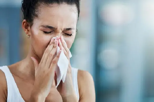 Cropped shot of an attractive young woman standing alone at home and feeling sick