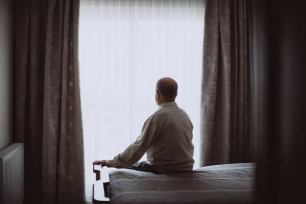 Growing old isn\\'t for sissies. Shot of a depressed senior man sitting on his bed at home