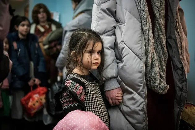 Children and their companions from an orphanage in Odesa, Ukraine, wait for room allocation after their arrival at a hotel in Berlin, Friday, March 4, 2022. More than 100 Jewish refugee children who were evacuated from a foster care home in war-torn Ukraine and made their way across Europe by bus have arrived in Berlin. (AP Photo/Steffi Loos)