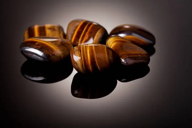 Group of Tiger Eye stones over black background