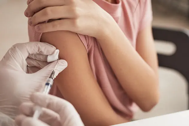 Close up of unrecognizable doctor vaccinating child in medical clinic, copy space