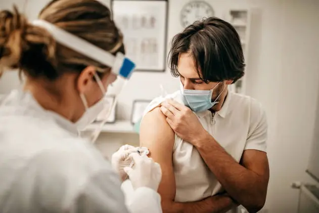 Medical doctor giving injection to make antibody for coronavirus