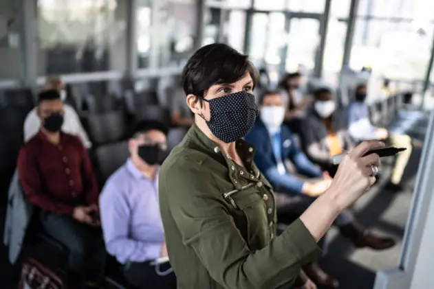 Businesswoman speaking at a business conference - with face mask