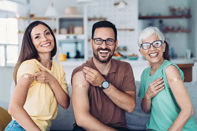 Portrait of three adults with adhesive bandages after covid-19 vaccination