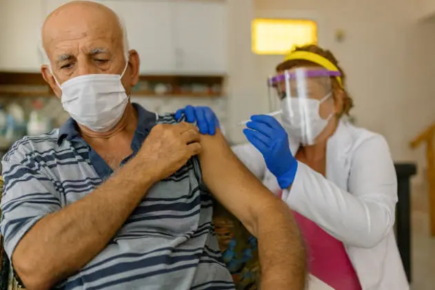 Senior patient getting vaccination at home