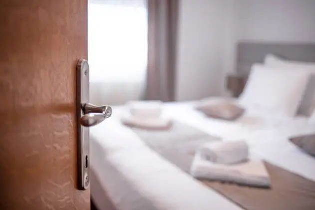 Entering the hotel room. Open the door. Hotel room , Condominium or apartment doorway with open door in front of blur bedroom background, Copy space image or text