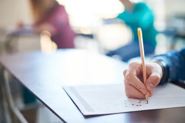 Hand of student filling out answers to a test