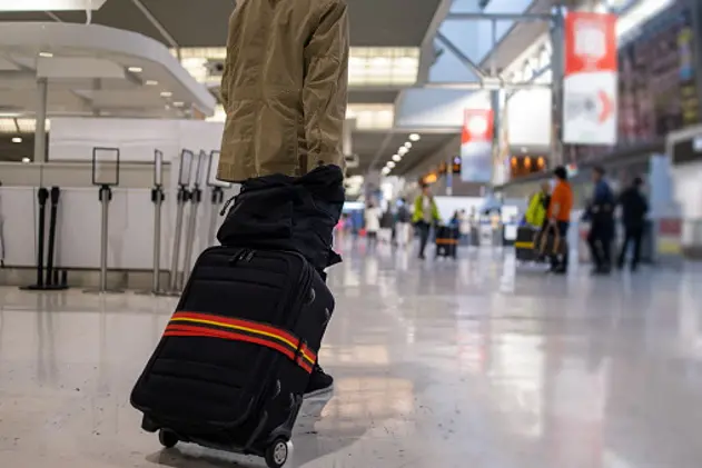 Teenage boy walking in airport for solo trip