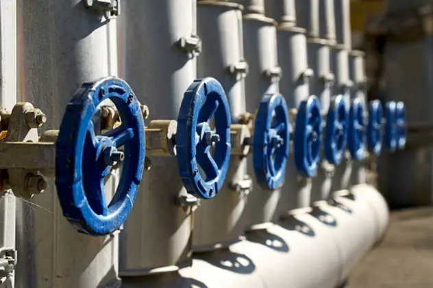 Phantom Blue industrial valves in a row on petrochemical plant pipelines system selective focus over out of focus background