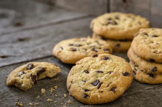 Rounded chocolate cookies on natural old desk.