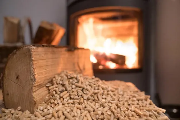 Wood stove heating with in foreground wood pellets - economical heating system concept