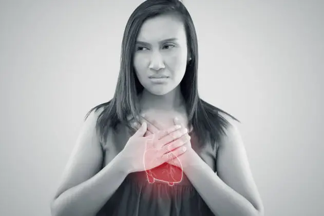 The photo of heart is on the woman\\'s body, Severe heartache, Having heart attack or Painful cramps, Angina Pectoris, Heart failure from coronary artery disease