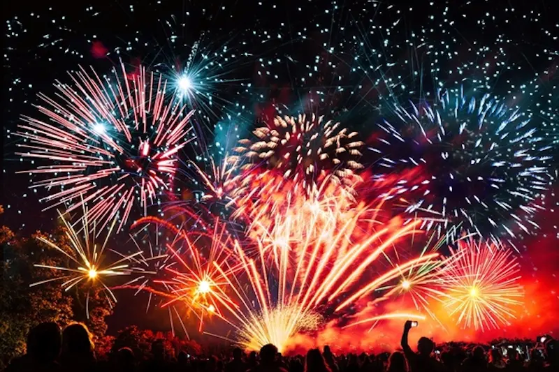 vibrant new years banner with  fireworks and cheering crowd