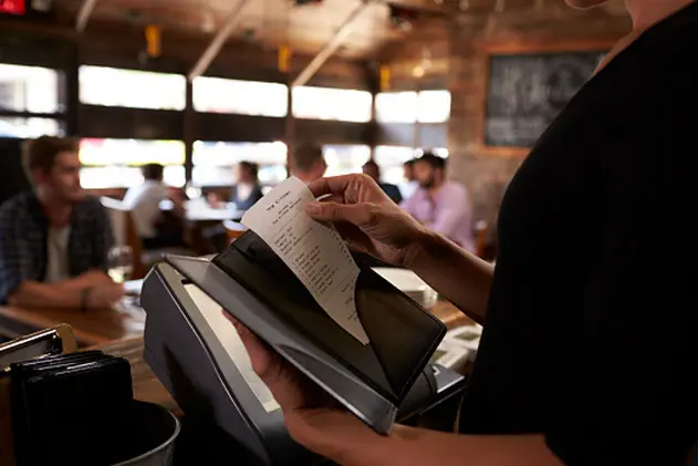 Preparing the bill at a restaurant to be taken to a table