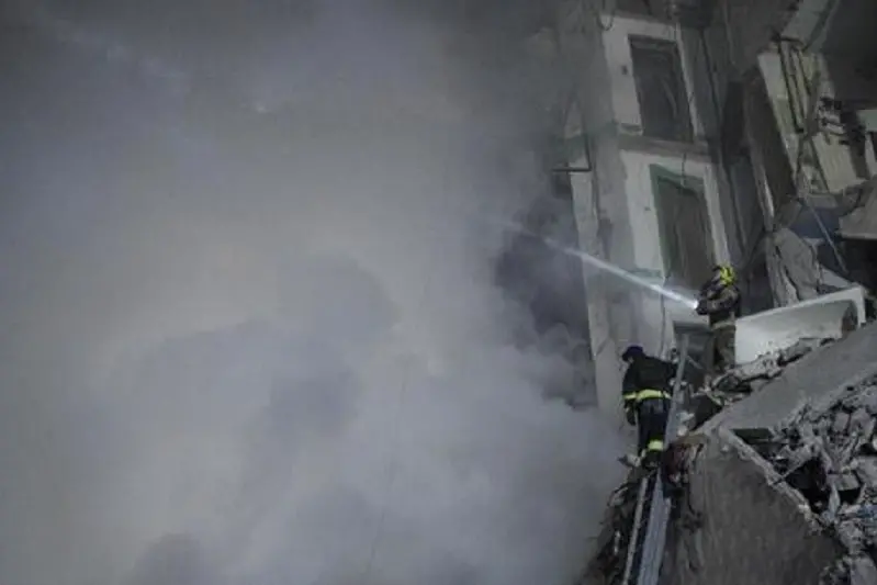 Rescuers works on a residential building destroyed after a missile strike, in Dnipro on January 14, 2023. - A strike on a residential building in the eastern Ukrainian city of Dnipro on January 14, 2023 killed at least five people and wounded 39, officials said, as the president blasted Russian \"terror\". (Photo by vitalii matokha / AFP)