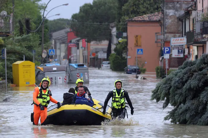 A family rescued by the firefighters in Coccolia, near Ravenna, Central Italy, 17 May 2023. For 24 hours the rescue operations continue following the wave of bad weather that is affecting the Emilia Romagna region. Six hundred firefighters are engaged in rescue operations with 200 vehicles, including four amphibians and two helicopters.   ANSA/PASQUALE BOVE