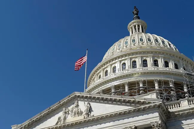 FILE - In this Tuesday, Sept. 6, 2016, file photo, an American flag flies over Capitol Hill in Washington. A group of six Gulf Arab countries expressed \"deep concern\" Monday over a bill passed by the U.S. Congress that would allow families of Sept. 11 victims to sue the government of Saudi Arabia over the attacks. (AP Photo/Susan Walsh, File)