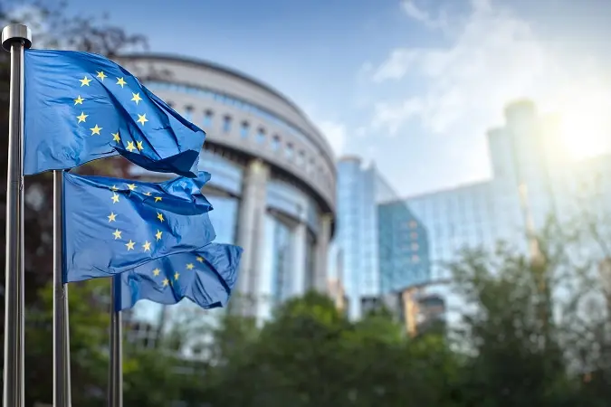 European union flag against parliament in Brussels, Belgium