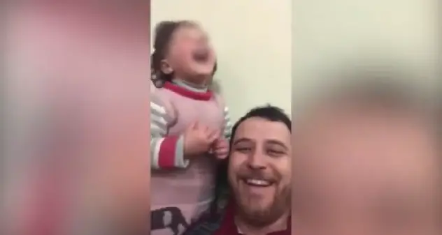 Siria. Cadono le bombe, papà inventa un gioco per distrarre la figlia | VIDEO