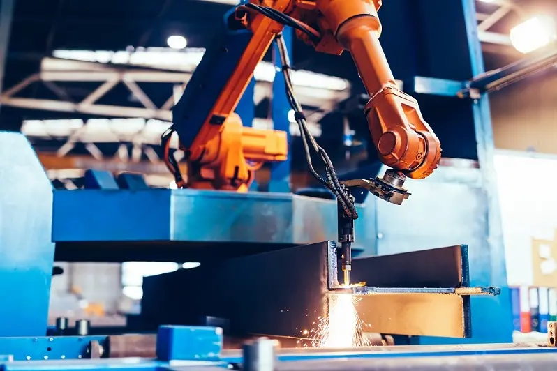 Robotic arm in a factory at work. Modern heavy industry, technology and machine learning