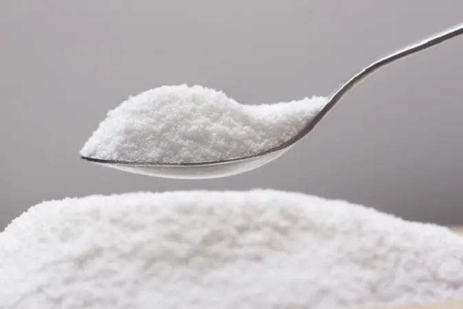 Put natural sweetener stevia from a pile into a spoon