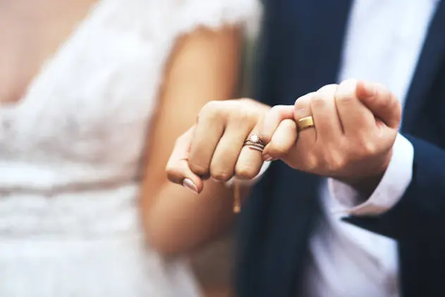 Cropped shot of an unrecognizable newlywed couple doing a pinky swear gesture on their wedding day