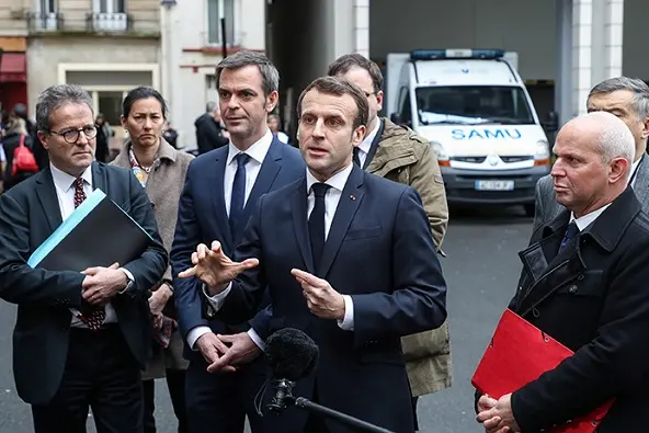 epa08283298 French President Emmanuel Macron (C) speaks to the press as he leaves with (from L) AP-HP President Martin Hirsch, French Health and Solidarity Minister Olivier Veran, and French director general of health Jerome Salomon, after a visit of the SAMU-SMUR emergency services call center at the Necker Hospital in Paris, 10 March 2020, focused on COVID-19 coronavirus outbreak.  EPA/LUDOVIC MARIN / POOL MAXPPP OUT