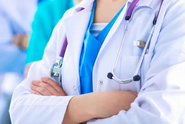 Attractive female doctor in front of medical group