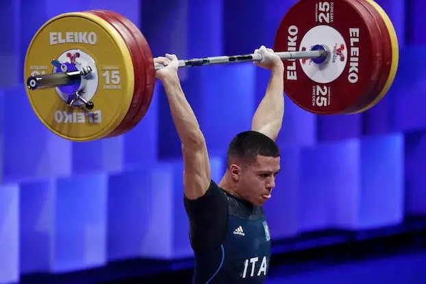 epa09116146 Sergio Massidda of Italy in action during the men\\'s 61kg category final at the 2021 EWF European Weightlifting Championships, in Moscow, Russia, 04 April 2021.  EPA/MAXIM SHIPENKOV