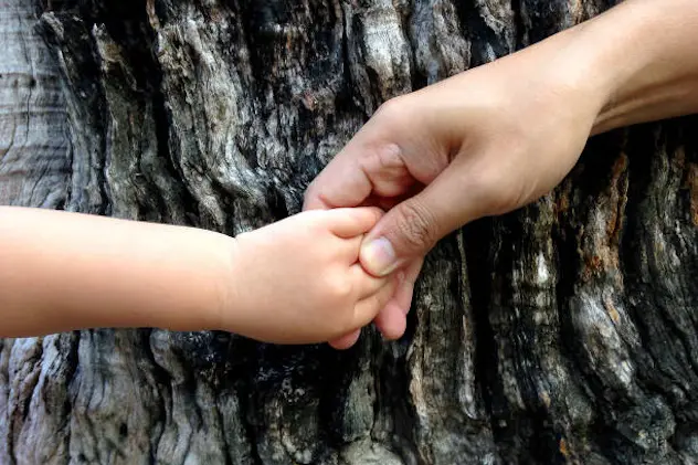 Father\\'s hand holding little kid\\'s hand for safe/healing and love concept