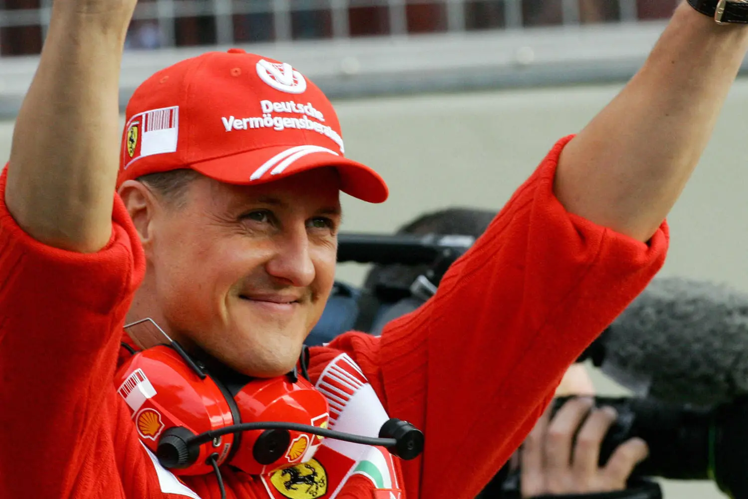 Former Ferrari driver Michael Schumacher waves to fans at the Mugello racetrack during the Ferrari Day event, 28 October 2007. The Ferrari team celebrates the victory in both the Constructors\\' and Drivers\\' 2007 championships in the company of Ferrari F1 drivers Kimi Raikkonen and Felipe Massa. AFP PHOTO / ANDREAS SOLARO (Photo credit should read ANDREAS SOLARO/AFP/Getty Images)