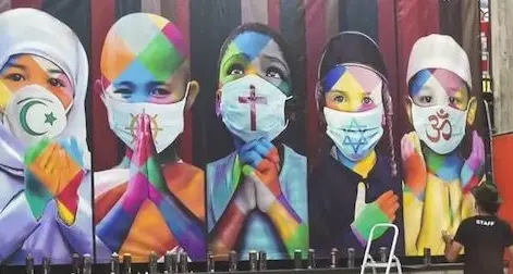 Coronavirus. L’artista brasiliano racchiude in un murales 5 religioni unite contro il virus