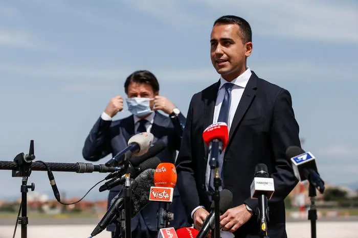 Italian Minister of Foreign Affairs Luigi Di Maio (L), listend by Italian Prime Minister Giuseppe Conte, wearing a protective face mask , delivers a speech to the press after welcoming  Italian cooperator Silvia Romano at the Ciampino airport, Rome, Italy, 10 May 2020. Silvia Romano was kidnapped on Novembre 2018 in Kenya. ANSA / FABIO FRUSTACI